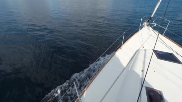 Bow of beautiful white yacht moves by sea. Foam waves breaking of sailboat. Slow motion. High Angle — Stock Video