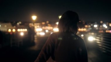 Funny smiling young millenial woman running on night embankment steadicam establish shot close up