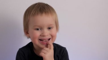 Close up portrait of doubt little cute child feeling confused hesitate and biting lips