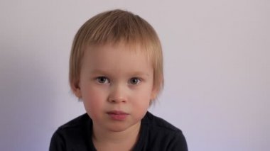 Close up portrait of cute little boy laughing having positive emotion face of happy child