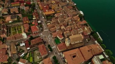 Panning aerial shot city infrastructure of old small town with moving car trafic and roof of house