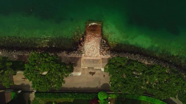 Flying over beautiful stone pier surrounded by natural seascape rising up aerial shot — ストック動画