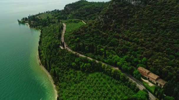 Aerial shot amazing natural mountain covered by green dense forest tree with speed highway — Stockvideo
