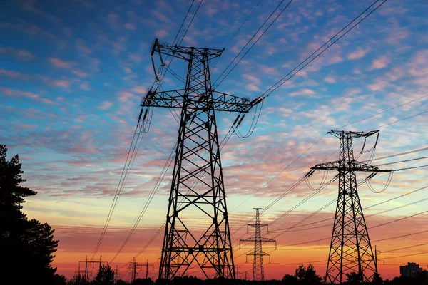 high tower electrical lines are silhouette on beautiful sunset.