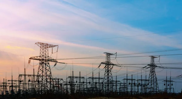 distribution electric substation with power lines, at sunset.