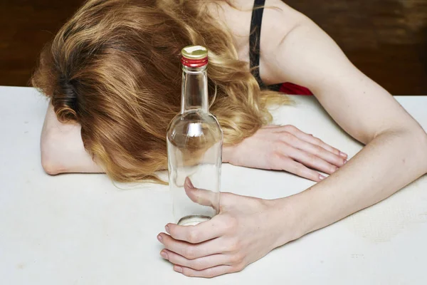 Drunk woman holding an bottle Stock Photo