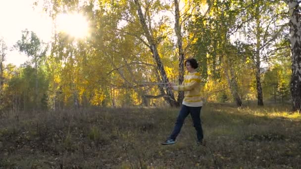 Slow Motion Acrobatics Young Girl in Autumn Forest on Sunny Day. — Stock Video