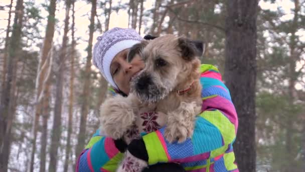 Mujer con un perro en un picnic junto al fuego. Día de invierno — Vídeos de Stock