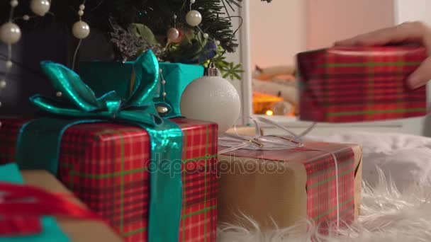 Poner regalos bajo el árbol de Navidad — Vídeo de stock