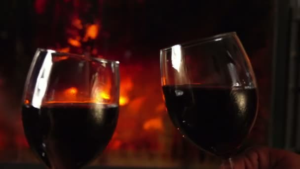 Glasses clink at the fireplace — Stock Video