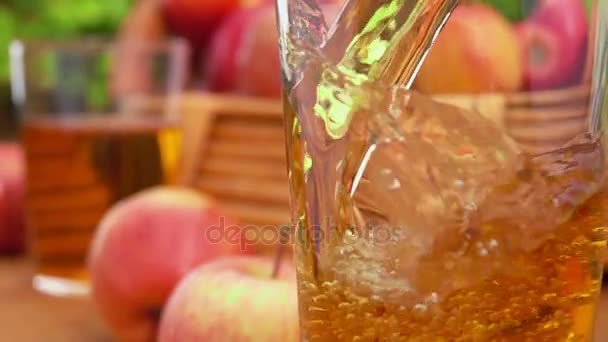 Apple juice äpple juice hälls i ett glas och korg äpplen — Stockvideo