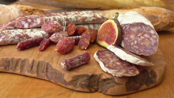 Uncooked jerked sausages, baguette and figs — Stock Video