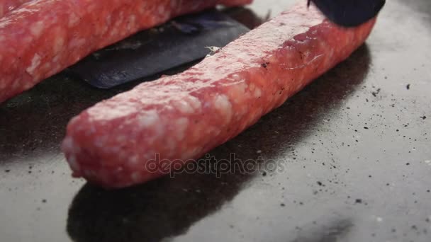 Putting sausages on a grill — Stock Video