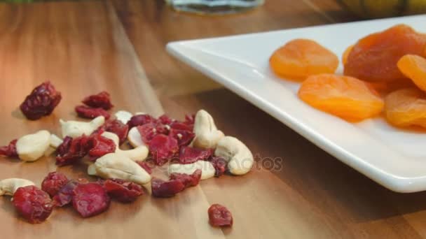 Dried fruits and nuts lying on the plate — Stock Video