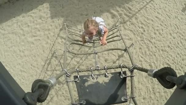 Little girl climbs up the ladder — Stock Video