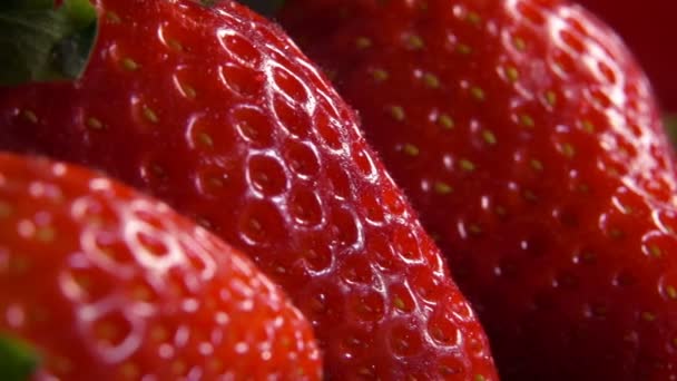 Drop of water dripping on a large ripe strawberries — Stock Video