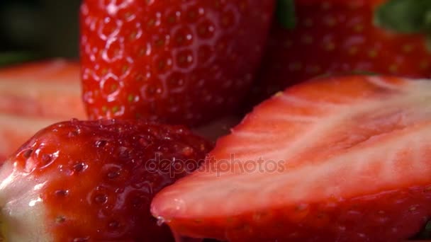 Drop of water drips on the half ripe strawberry — Stock Video