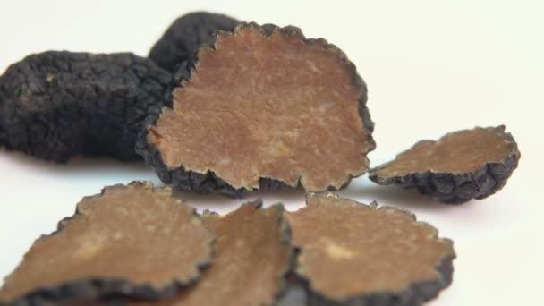 Slices of black truffle lying on a white surface — Stock Video