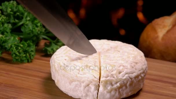 Knife carves a sector of French round cheese — Stock Video