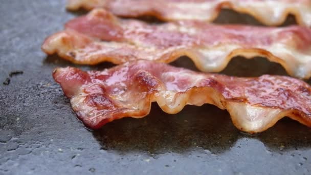 Close-up of a slice of bacon fried on grill — Stock Video