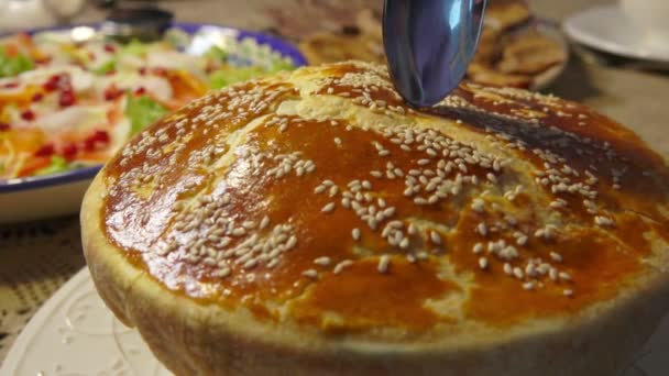 Spoon breaks the top of puff pastry hunting soup — Stock Video
