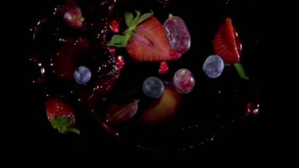 Mixed berries with juise flies to the camera — Stock Video