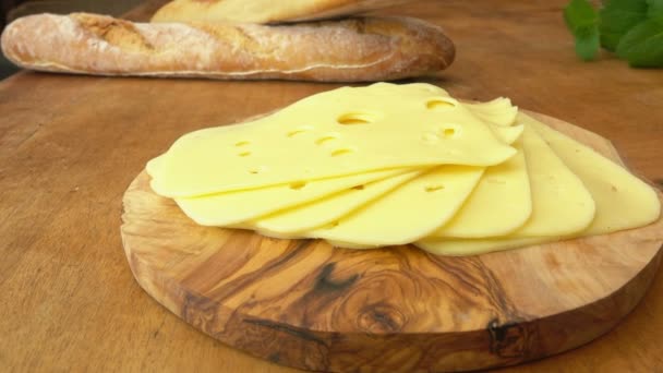 Holland maasdam cheese on a wooden board — Stock Video