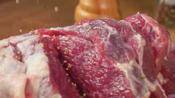 Closeup of spices falls on the leg of lamb — Stock Video