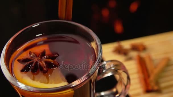 Paus de canela caindo de cima em uma caneca agradável de vinho quente — Vídeo de Stock