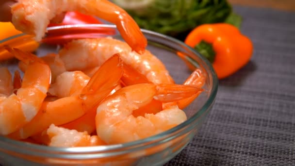 Hand puts juicy tasty shrimps in a bowl — Stock Video