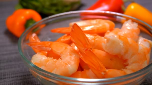 Hand puts juicy tasty shrimps in a bowl — Stock Video