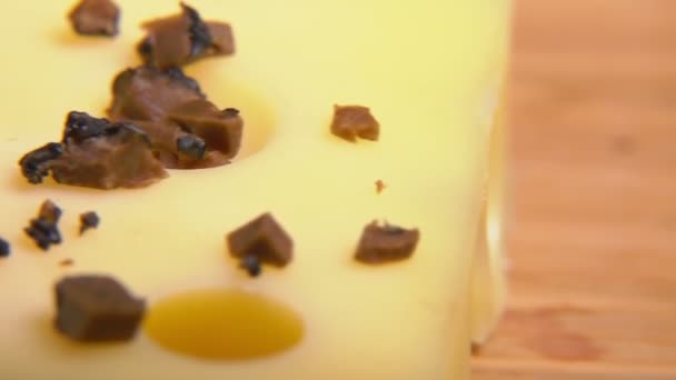 Cubes of black truffle fall on hard cheese — Stock Video