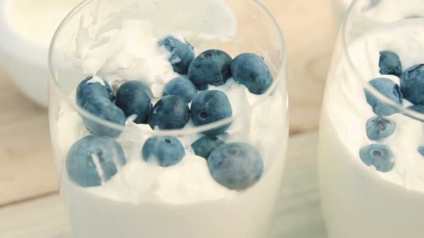Blueberry in a glass with whipped cream — Stock Video