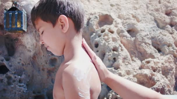 Mamma gips pojkar ansiktskräm för solskydd — Stockvideo