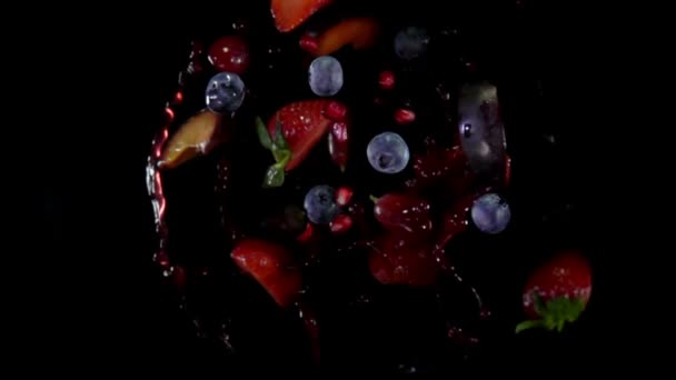 Mixed berries with juise flies to the camera — Stock Video