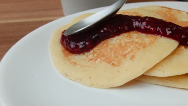 Jam superimposed spoon on pancakes — Stock Video