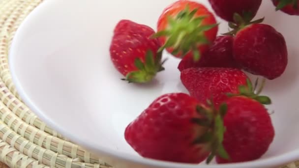 Close-up Strawberry falling in the white bowl — Stock Video