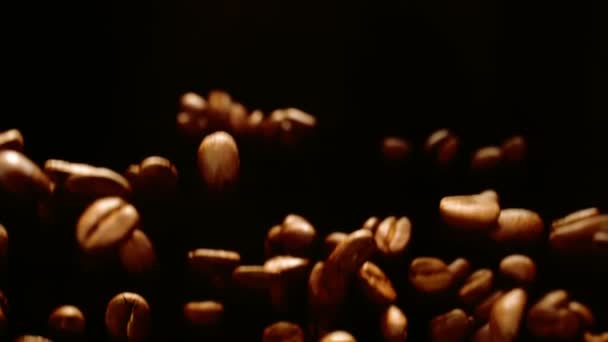 Roasted coffee beans fly and spin in slow motion — 图库视频影像