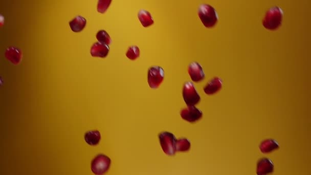 Pomegranate grains falling on yellow background — Stock Video