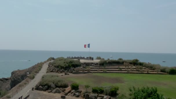 Aerial shot of the flag of France above the sea — стокове відео