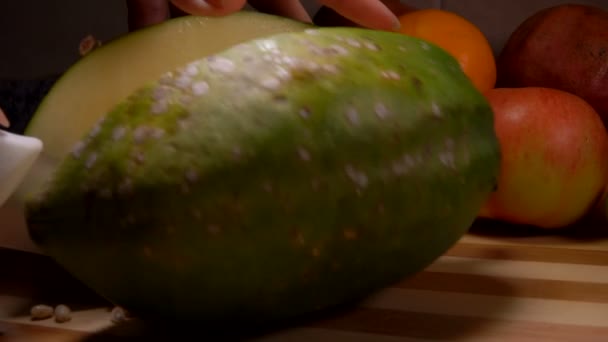 Groene papaja in tweeën gesneden met een mes — Stockvideo