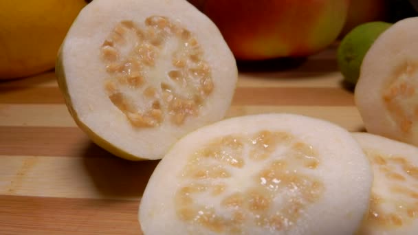 Exotic Guava slices are lying on a bamboo board — Stock Video