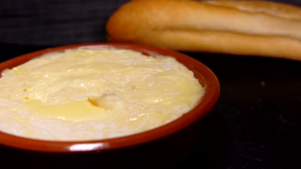 Baguette dipped in preheated Saint-Felicien cheese — Stock Video