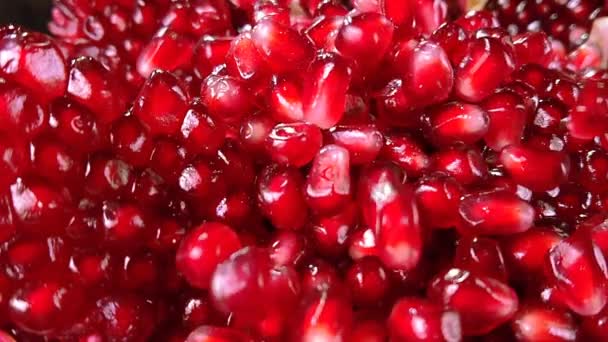 Fresh grains fall down on a pile of pomegranate — Stockvideo