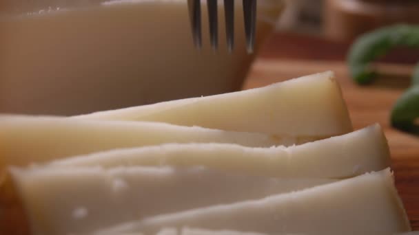 Κοντινό πλάνο ενός σκληρού πρόβειου τυριού που λαμβάνεται με ένα πιρούνι — Αρχείο Βίντεο