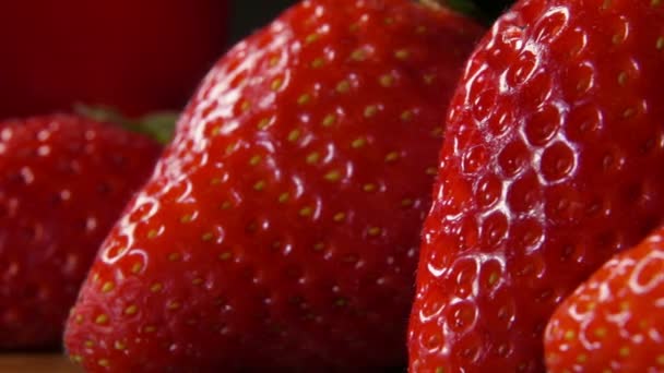 Erdbeeren mit Wassertropfen, die über die Oberfläche fließen — Stockvideo