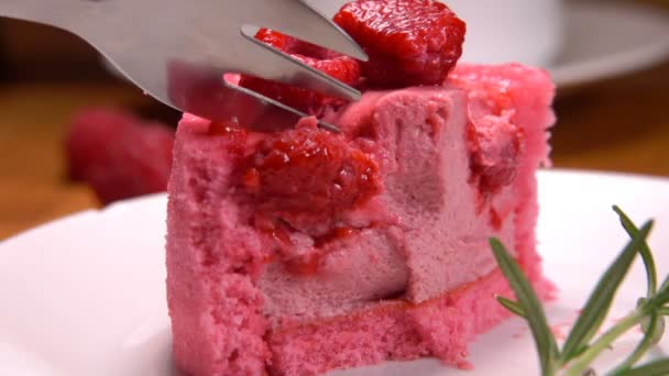 Fork takes piece of mousse raspberry French pastry — Stock Video