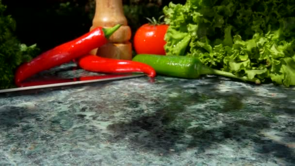 Raw meat falls flat on the stone surface on the background of vegetables — Stock Video