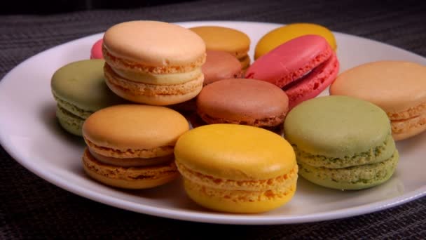 Many hands take macaroons from a plate — Stock Video