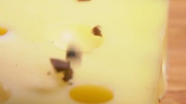 Chopped rare black truffle mushroom is falling on the cheese